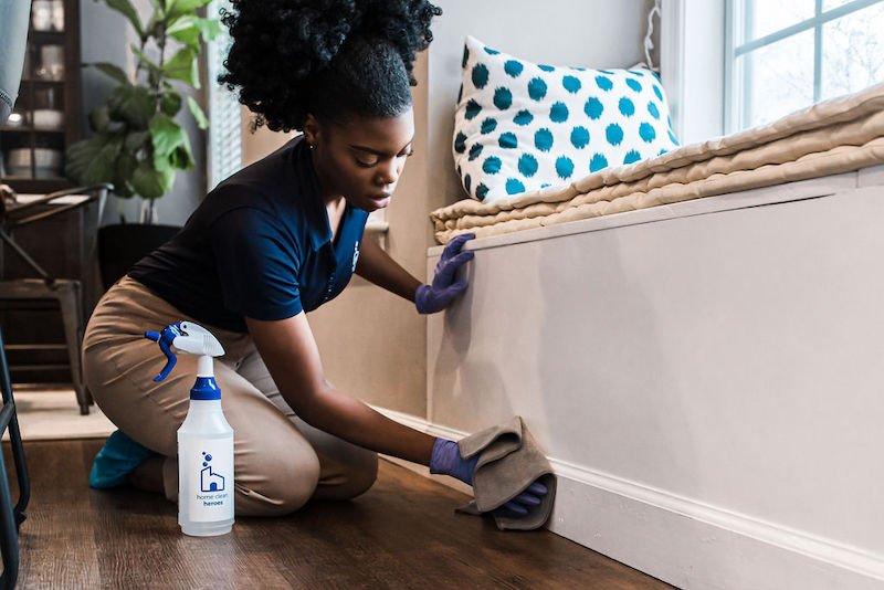 home clean heroes cleaner wiping down baseboards