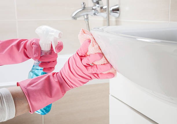 housemaid cleaning a bathroom, closeup shot